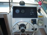 The helm.  Black bracket to right of wheel is for a Humminbird "Wide Onehundred" which was included.