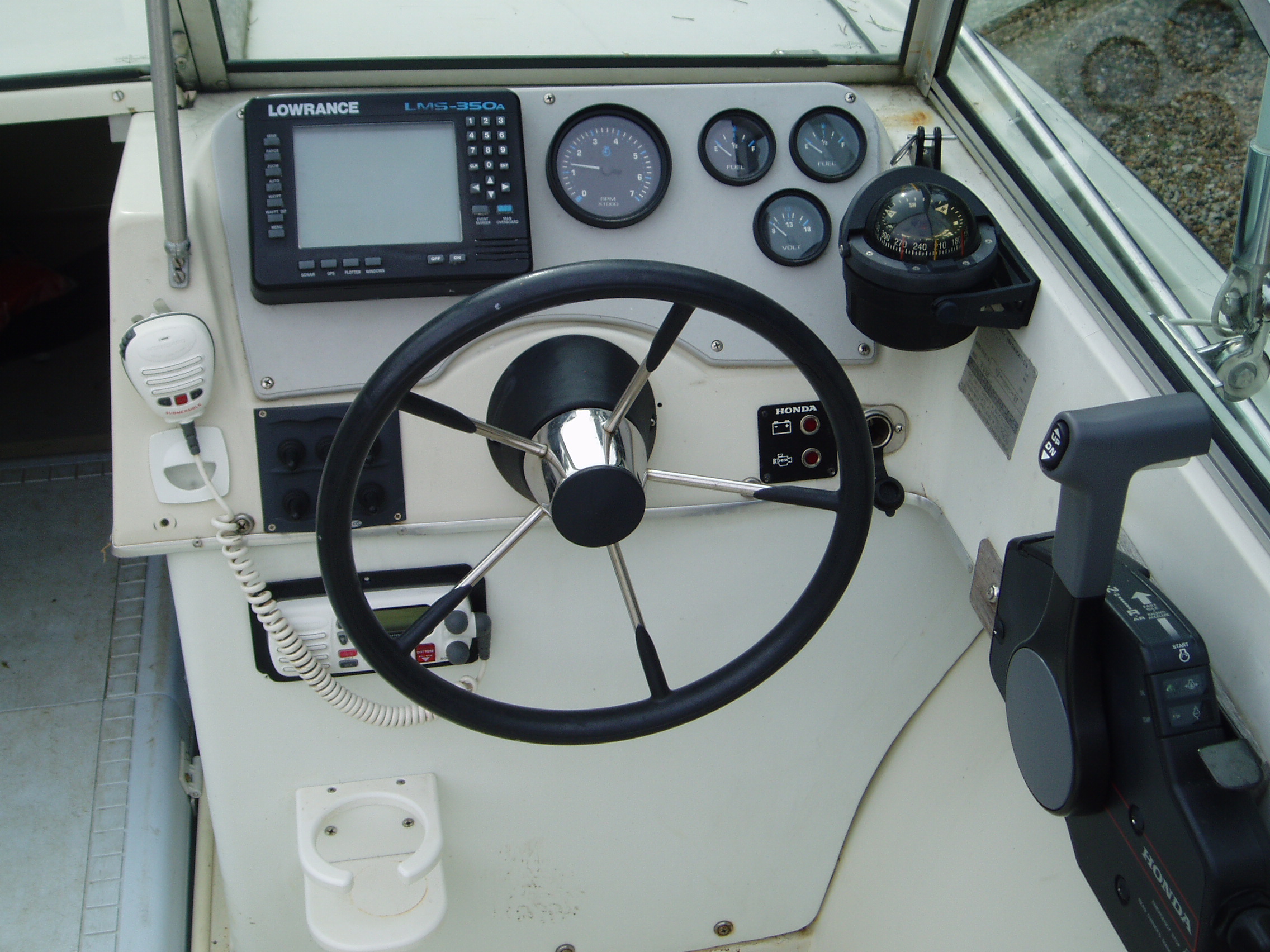 Old LMS 350(sonar and GPS) built into dash...essential gauges only; 2 fuel, volt and tach...VHF mike handy, but hard to see display on radio...gotta t